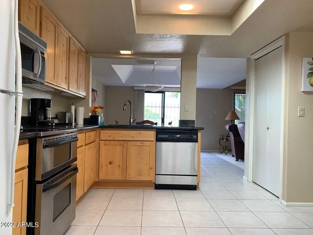 a kitchen with stainless steel appliances granite countertop a refrigerator and a stove