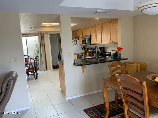 a kitchen with a refrigerator and a sink