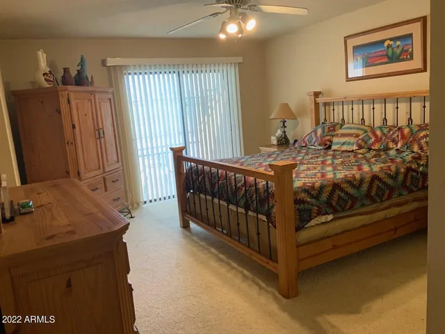 a bed sitting in a bedroom next to a window