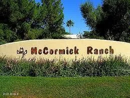 a view of a lake with a yard and large trees