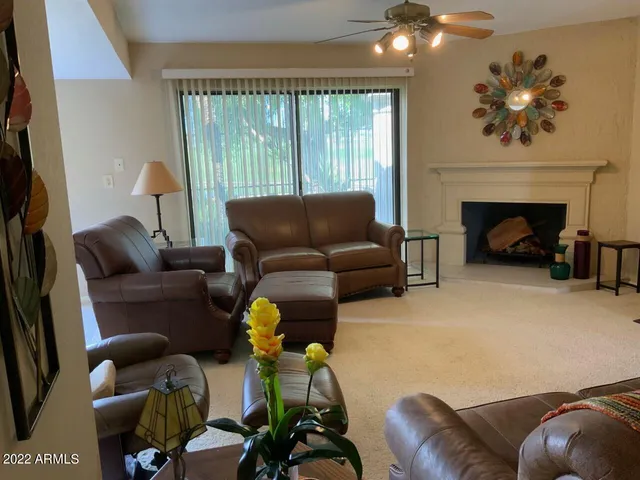 a living room with furniture and a fireplace