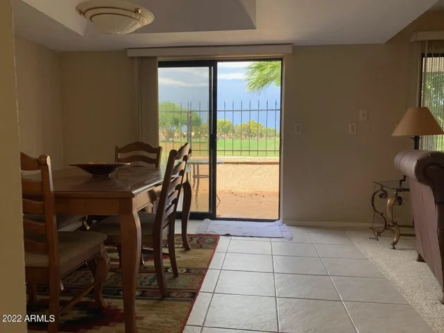 a view of a workspace with furniture and a window