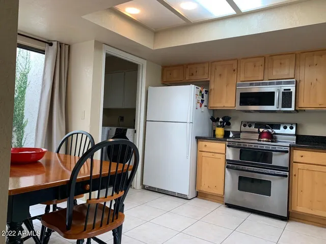 a kitchen with stainless steel appliances a stove a sink and a refrigerator