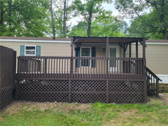 a view of a house with a wooden deck