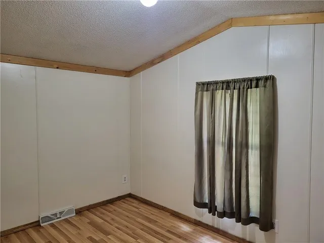 a view of a room with wooden floor
