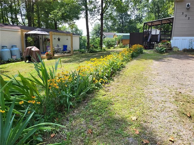 a view of a house with backyard and sitting area