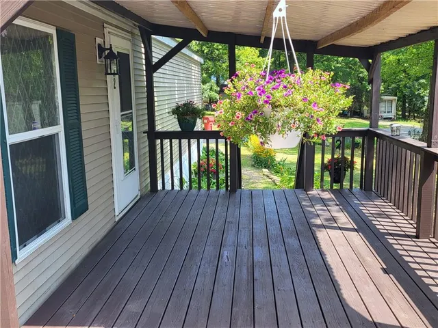a view of a balcony with wooden floor