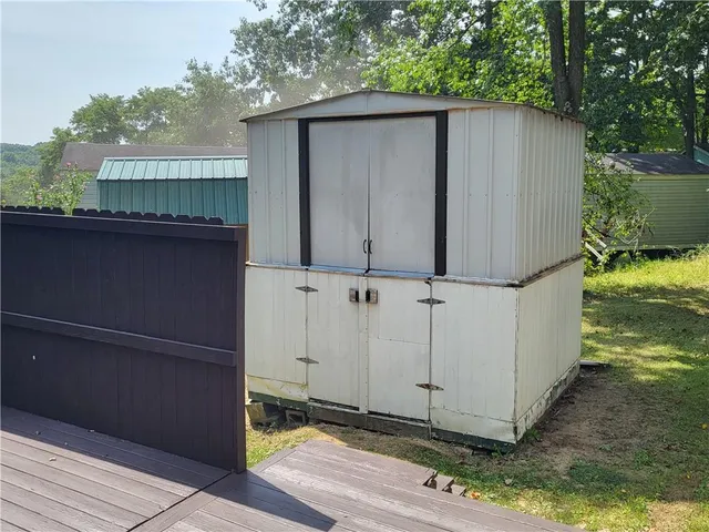 a view of backyard of house with green space