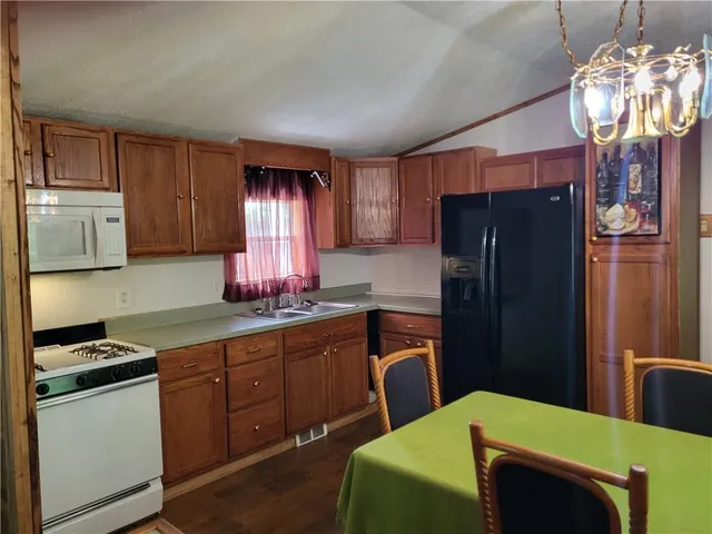 a kitchen with stainless steel appliances a refrigerator stove and sink