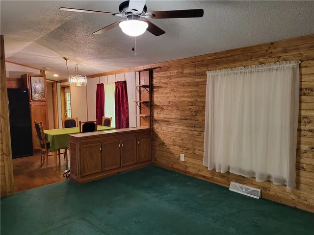 a room with lots of wooden furniture and a large window