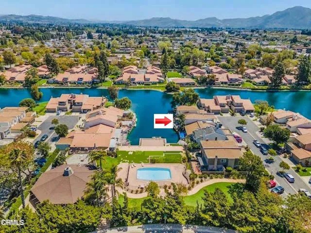 an aerial view of a houses with a lake