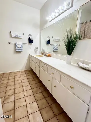 a spacious bathroom with a double vanity sink mirror and
