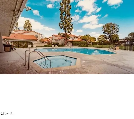 a picture of a building with a garden and sitting area