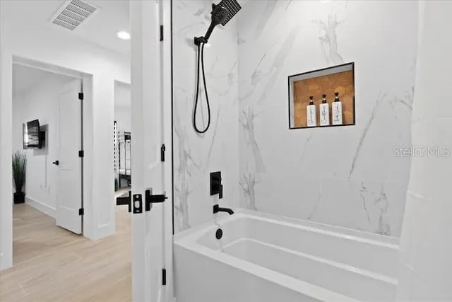 a bathroom with a bathtub and a shower