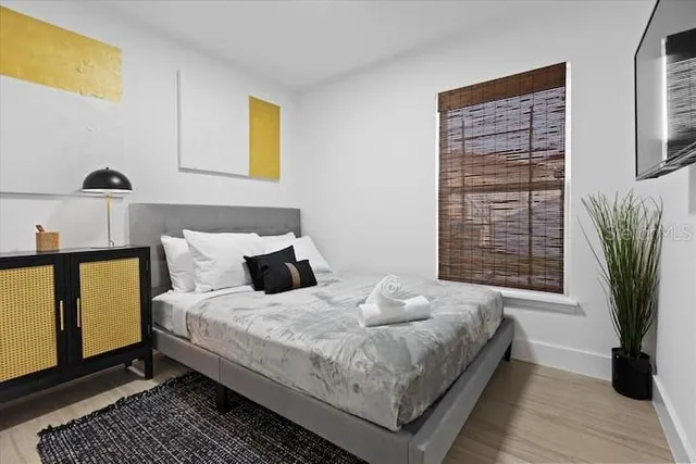 a bedroom with a bed and a window