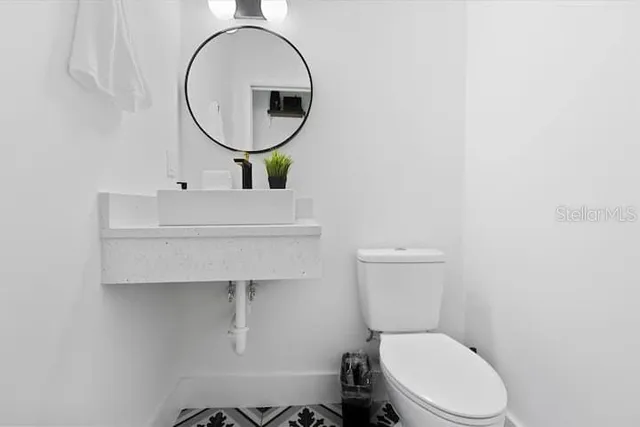 a bedroom with a bed and a lamp