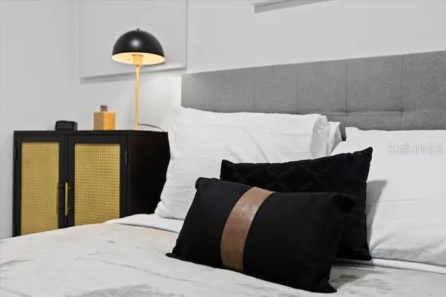 a bedroom with a bed and window