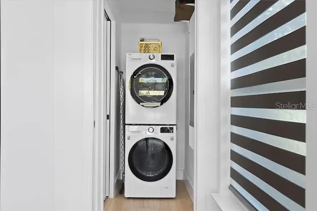 a bedroom with a bed and painting on the wall