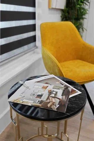 a view of a dining room with furniture and a potted plant