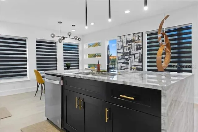 a kitchen with stainless steel appliances granite countertop a sink and a counter