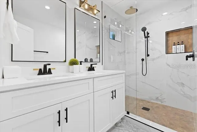 a bathroom with a shower sink and mirror