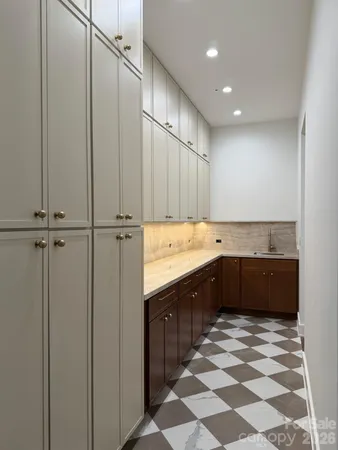 a large kitchen with stainless steel appliances granite countertop a sink and cabinets
