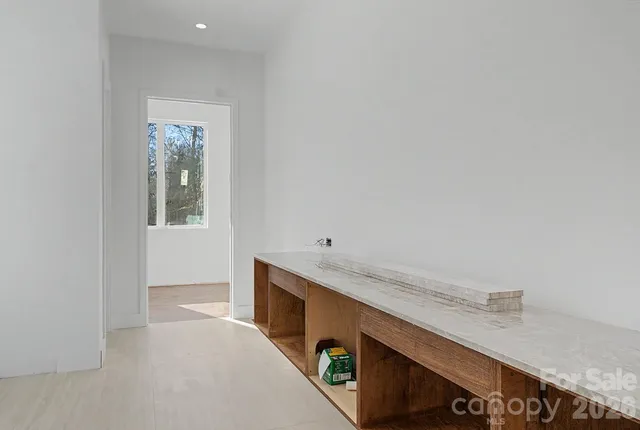 a room with a sink cabinets and a window