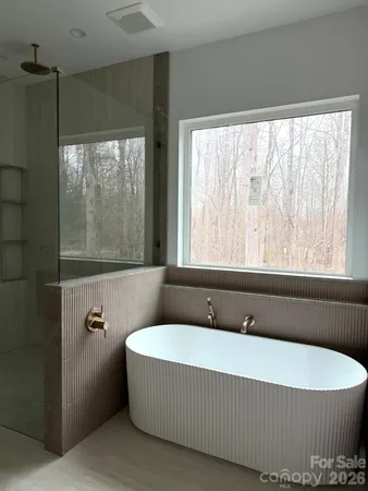 a bathroom with a bathtub and window