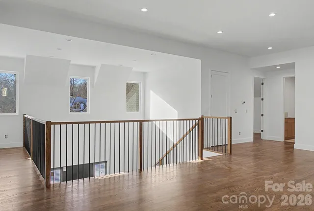 a view of a hallway with wooden floor