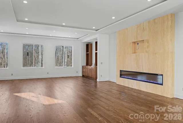 a view of wooden floor and windows in a room