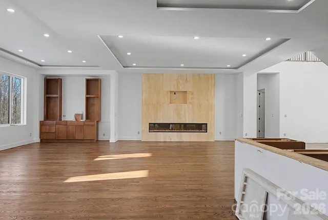 a view of a kitchen with stainless steel appliances granite countertop a stove and a refrigerator
