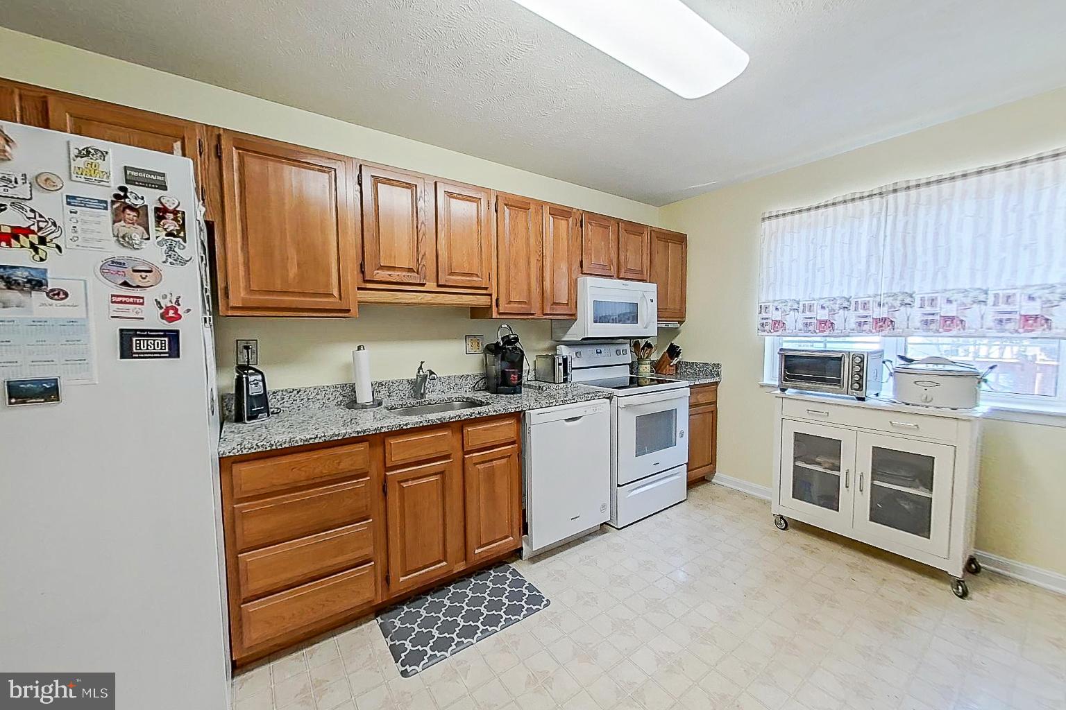1 Bancroft Street Taneytown, MD 21787 - Photo 11 of 35 a kitchen with stainless steel appliances granite countertop a stove sink and cabinets