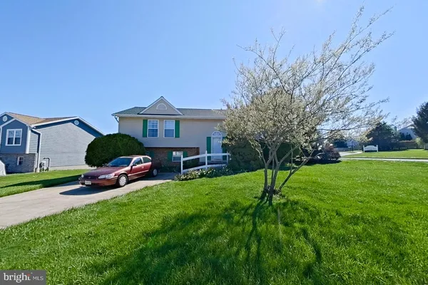 a view of a house with a yard and sitting area