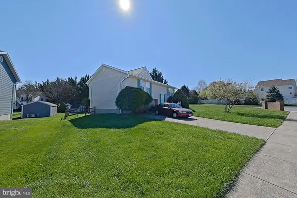 a aerial view of a house with yard and a fence
