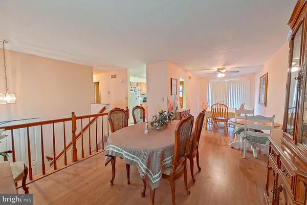 a view of a a dining room with furniture window and wooden floor