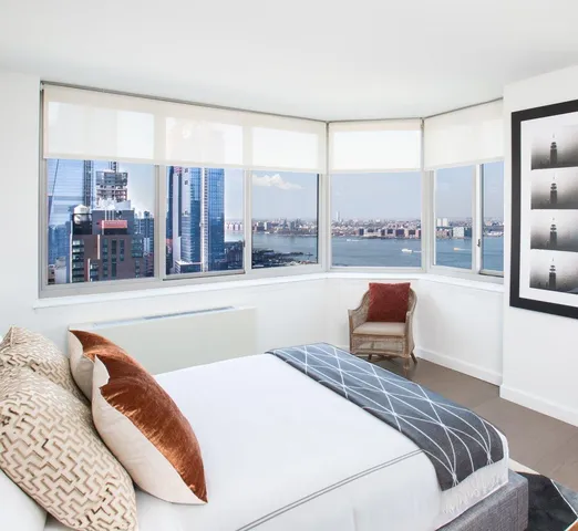 a bedroom with a large bed and a large window