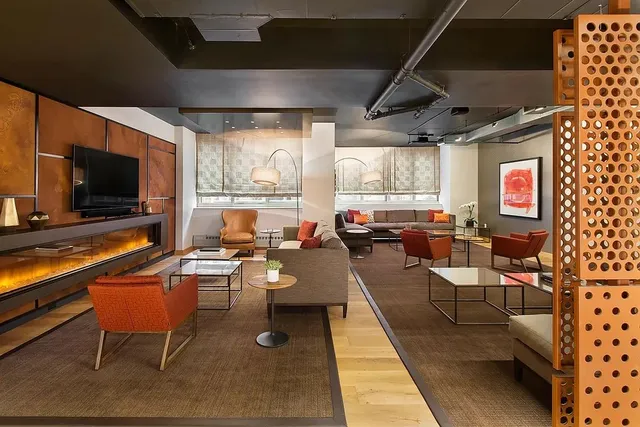 a living room with fireplace furniture and a flat screen tv