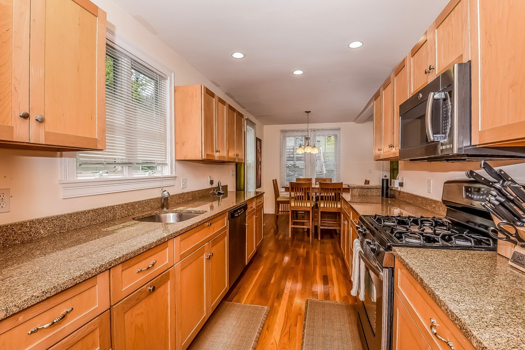 17 Thurston Road, Unit 17 Newton, MA 02464 - Photo 8 of 24 a kitchen with wooden cabinets and sink
