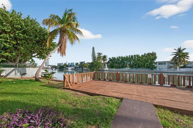 a view of a balcony with wooden floor and lake view
