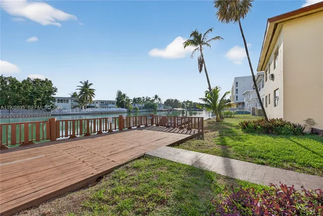 a view of a kitchen with a sink and wooden floor