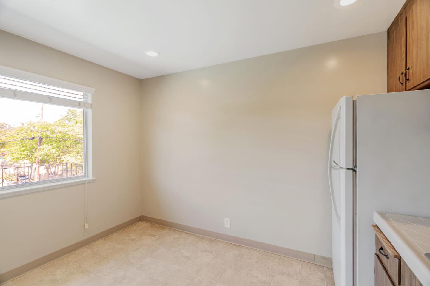 869 Bing Drive Santa Clara, CA 95051 - Photo 7 of 11 a view of a kitchen with wooden floor and window