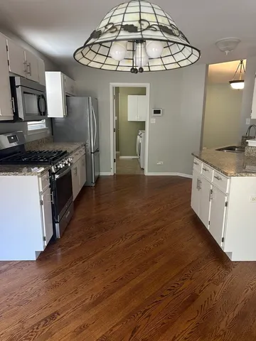 a kitchen with stainless steel appliances granite countertop a sink and stove top oven