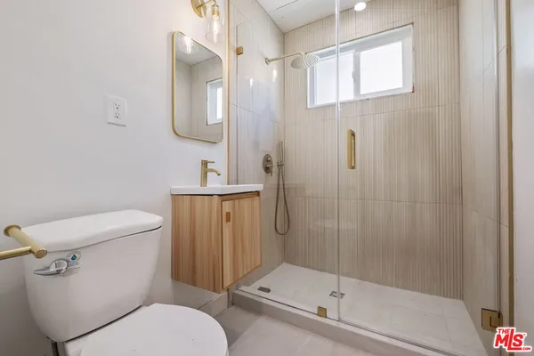 a white toilet sitting next to a bathroom sink