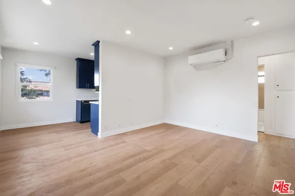 a kitchen with kitchen island granite countertop wooden cabinets a stove top oven a sink and dishwasher