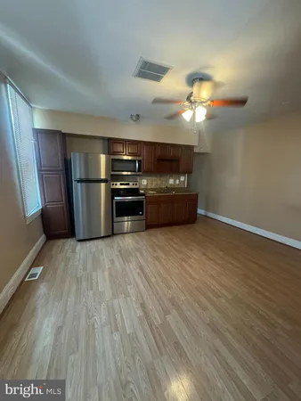 a kitchen with stainless steel appliances a refrigerator and a microwave