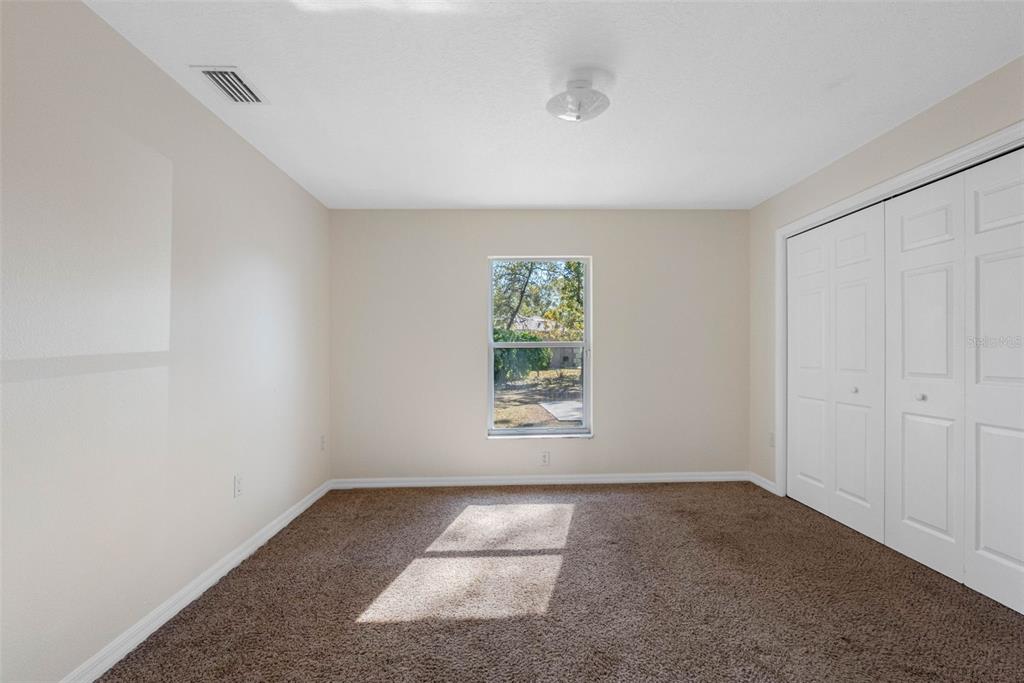 9336 Tooke Shore Drive Weeki Wachee, FL 34613 - Photo 18 of 44 an empty room with a empty space and windows