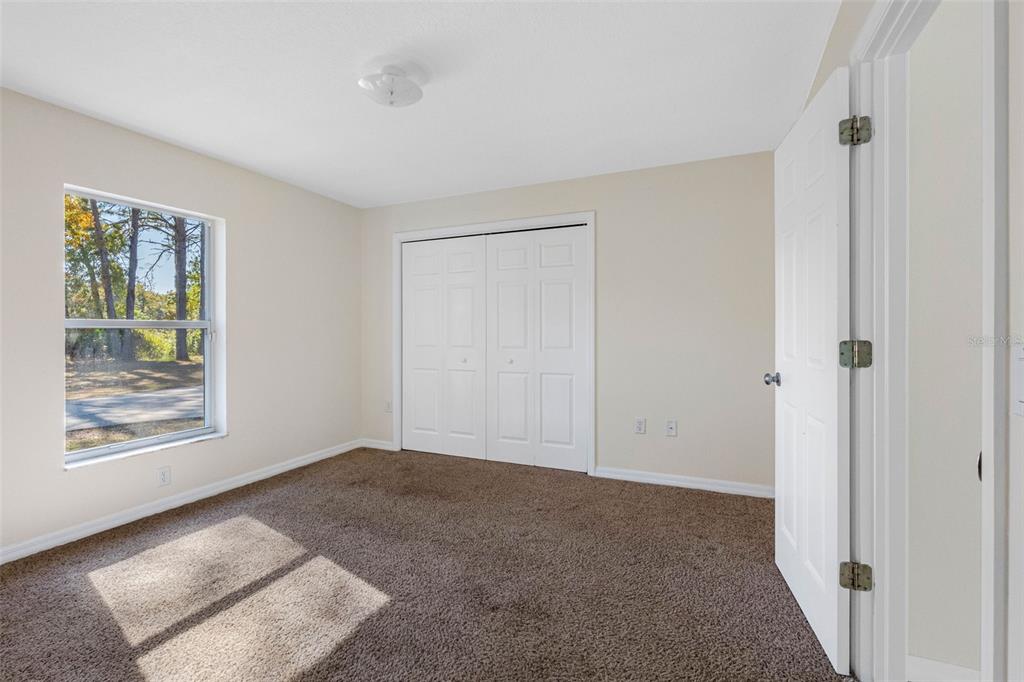 9336 Tooke Shore Drive Weeki Wachee, FL 34613 - Photo 19 of 44 a view of an empty room with window and closet area
