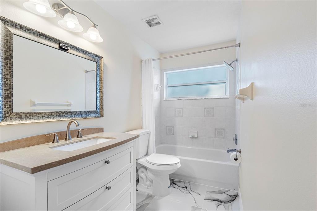 9336 Tooke Shore Drive Weeki Wachee, FL 34613 - Photo 20 of 44 a bathroom with a sink a toilet and shower