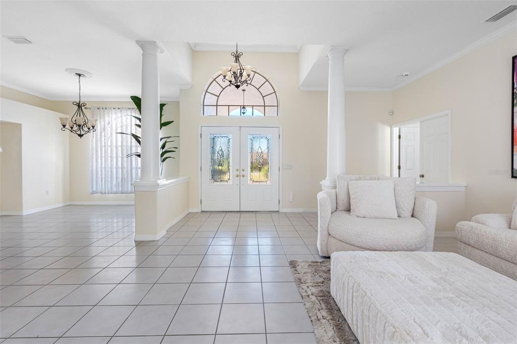9336 Tooke Shore Drive Weeki Wachee, FL 34613 - Photo 24 of 44 a living room with furniture a window and a chandelier