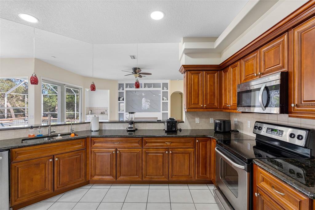 9336 Tooke Shore Drive Weeki Wachee, FL 34613 - Photo 5 of 44 a kitchen with a sink stove and microwave